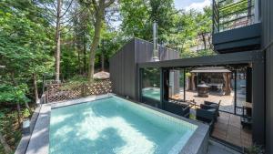 a swimming pool in the backyard of a house at gwangju chez pompom dokchae poolvilla in Gwangju