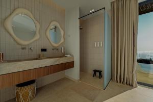 a bathroom with a large mirror and a sink at Tellion Villas-Member of My Villas Hospitality in Agios Nikitas +49 photos