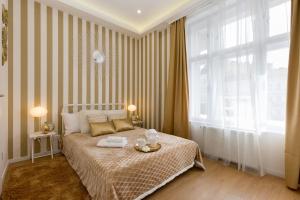 a bedroom with a bed and a large window at Stylish Studio Collection Central Budapest in Budapest
