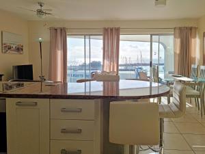 a kitchen and dining room with a table and chairs at '11 Gordonia'- 2 En-suite Bedrooms, Beach access & Great location in Cape Town