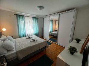 a bedroom with a bed and a large mirror at House Burić in Senj