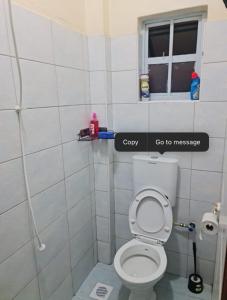 a bathroom with a toilet and a window at MillyJay in Gatunga