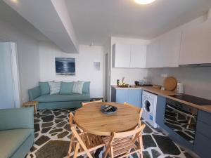 a kitchen with a table and chairs in a room at Stella's Studio in Galissas