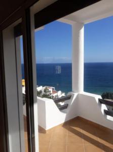 a room with a view of the ocean from a balcony at Villa The View in Tétouan +38 photos