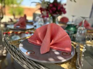 a red napkin on a plate on a table at El MELK MANSOUR in Essaouira