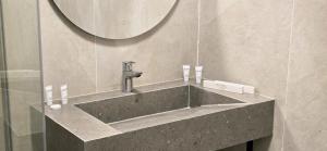 a bathroom with a sink with a mirror at Naya Hotel in Almaty +71 photos