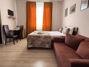 a living room with a couch and a bed at Liva Hotel in Tbilisi City