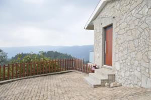 a stone building with a staircase next to a fence at Casa Vale Quintao in Geres