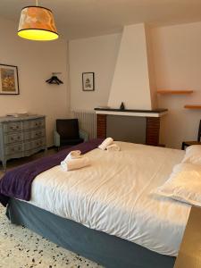 a bedroom with a large bed with towels on it at Chez Marie in Linguizzetta