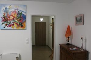 a hallway with a painting on the wall next to a door at BIENVENUE EN BAIE De SOMME in Saint-Valery-sur-Somme