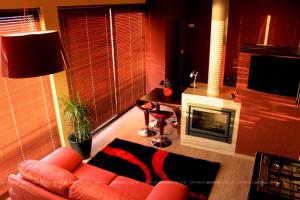 a living room with a couch and a fireplace at Casa Vale Quintao in Geres