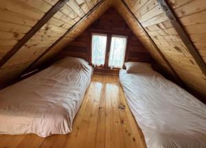 a bedroom with two beds in a attic at Kraljeva breza in Divčibare