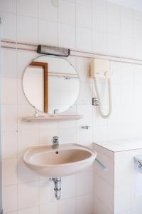 a bathroom with a sink and a mirror at Hotel Allee 25 in Stuttgart +59 photos