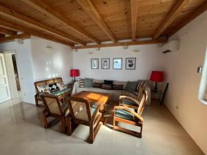 a living room with a couch and a table and chairs at Villa Tramonto in Sutivan