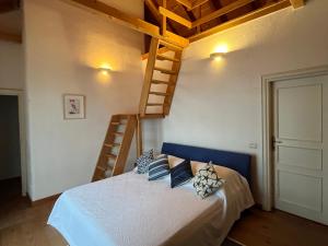 a bedroom with a bed with two pillows and a ladder at Villa Tramonto in Sutivan