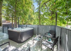 a hot tub on a deck with a fence at SL14 - The Watchtower with Hot Tub in Bethesda