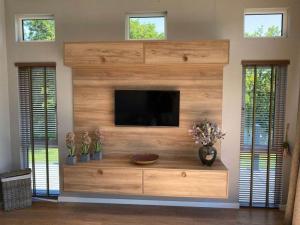 a living room with a flat screen tv on a wall at SL14 - The Watchtower with Hot Tub in Bethesda