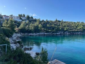 a view of a river with houses on a hill at Villa Tramonto in Sutivan