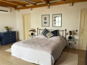 a bedroom with a large bed and two tables at Villa Tramonto in Sutivan +7 photos