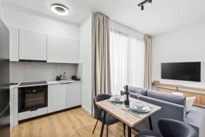 a kitchen and living room with a table and chairs at Artemis 103 - Seaside Stories in Livadhia