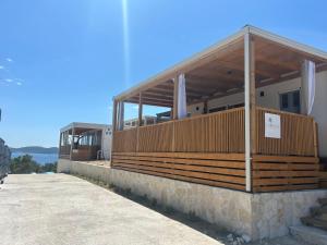 a building with awning on the side of it at Mobile home La Bella in Drage