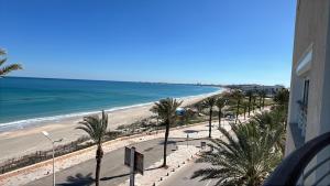 a view of a beach with palm trees and the ocean at Mahdia front sea balcony 2 in Hiboun