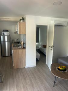 a kitchen and a living room with a table in a room at Mobile home La Bella in Drage