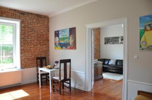 a living room with a table and a brick wall at BE WELL 3-Rooms Apartment with Parking and Garden in Warsaw
