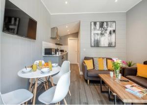 a living room with a table and a couch at V28 - The Lookout with Hot Tub in Bethesda +8 photos