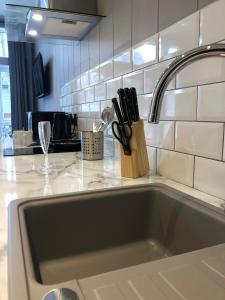 a kitchen counter with a sink and a knife block at V28 - The Lookout with Hot Tub in Bethesda