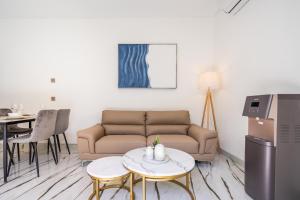 a living room with a couch and a table at Frelin Villas - 1 BR, 2 BR Luxury Villa Complex in Kerobokan
