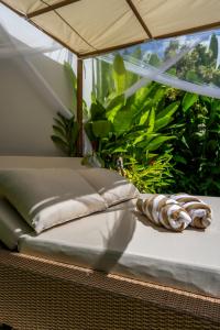 a bed in a room with an umbrella at Frelin Villas - 1 BR, 2 BR Luxury Villa Complex in Kerobokan