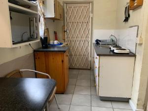 a small kitchen with a counter and a table at Venolla's in The Crags