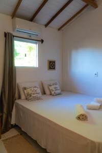 a bedroom with a large bed with a window at Hospedaria Luar de Trancoso in Trancoso