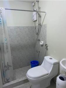 a bathroom with a shower and a toilet and a sink at Amaia Steps Altaraza Staycation in Sapang Alat