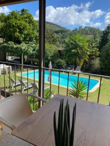 a view of the pool from the balcony of a house at Quinta dos Mouras in Celorico de Basto