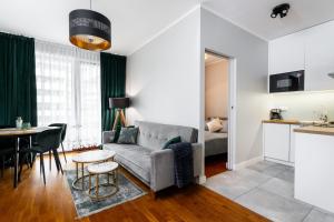 a living room with a couch and a table at Business Suites Arkadia by VAYA STAYS in Warsaw