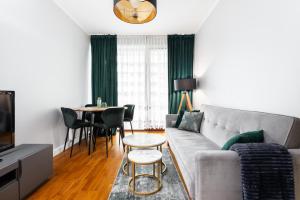 a living room with a couch and a table at Business Suites Arkadia by VAYA STAYS in Warsaw