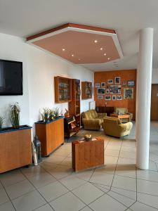 a lobby with couches and a flat screen tv at Hotel Sonnenhof - Tante ALMA`s Sommerfrische in Sonnen