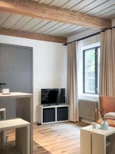a living room with a flat screen tv sitting on a table at Ferienwohnung 2, Schlaf-Gut-Johannis, Flensburg in Flensburg