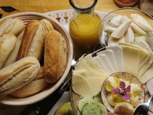 a table with a plate of bread and other foods at Kylstad Bed and Breakfast in Kylstad