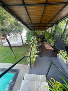 a patio with a table and a bench and a pool at Airport waterfront chalet in Katunayake