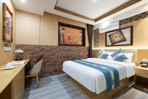 a hotel room with a bed and a desk at East Sacred Hotel-Very close to the Drum Tower,The Lama Temple,Houhai Bar Street,Nanluoguxiang,Tiananmen Square and the Forbidden City, and the subway st ation is also very close in Beijing