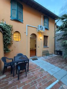 a house with a table and chairs on a brick patio at B&B Emilia 330 Imola Centro Apartment in Imola