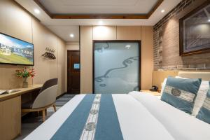 a hotel room with a large bed and a sliding door at East Sacred Hotel-Very close to the Drum Tower,The Lama Temple,Houhai Bar Street,Nanluoguxiang,Tiananmen Square and the Forbidden City, and the subway st ation is also very close in Beijing