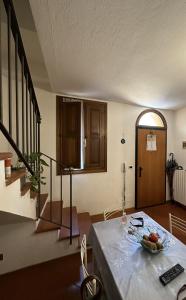 a living room with a table with a bowl of fruit on it at B&B Emilia 330 Imola Centro Apartment in Imola
