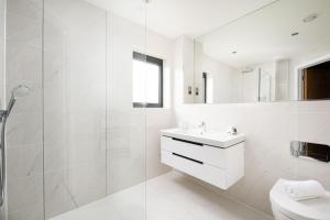 a white bathroom with a sink and a shower at Howard Lodge BV27 Silverlake Dorset in Warmwell +34 photos