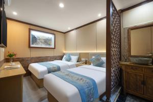 a hotel room with two beds and a sink at East Sacred Hotel-Very close to the Drum Tower,The Lama Temple,Houhai Bar Street,Nanluoguxiang,Tiananmen Square and the Forbidden City, and the subway st ation is also very close in Beijing