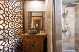 a bathroom with a sink and a shower at East Sacred Hotel-Very close to the Drum Tower,The Lama Temple,Houhai Bar Street,Nanluoguxiang,Tiananmen Square and the Forbidden City, and the subway st ation is also very close in Beijing