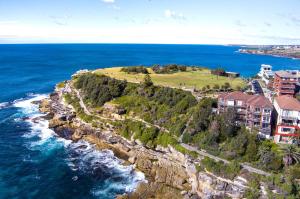 an aerial view of a house on a cliff next to the ocean at Ultimate Bondi Escape #2 Stunning Views ! in Sydney